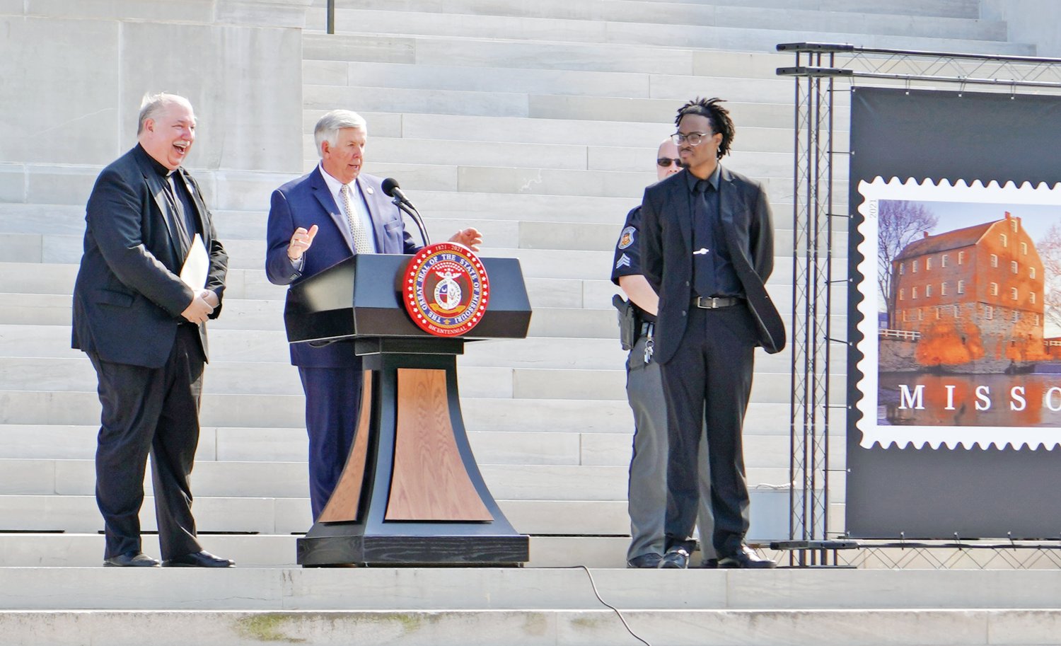 Monsignor Robert A. Kurwicki, vicar general of the Jefferson City diocese and chaplain of the Missouri House of Representatives, joins Gov. Mike Parson and Missouri State University Adjunct Professor James T. Gibson on the steps of the Capitol during the Aug. 10 Statehood Day celebration marking Missouri’s 200th anniversary as the 24th state in the Union.